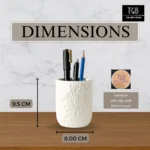 Concrete pen holder displayed beside an A5 notebook and standard pens to demonstrate its size and storage capacity.