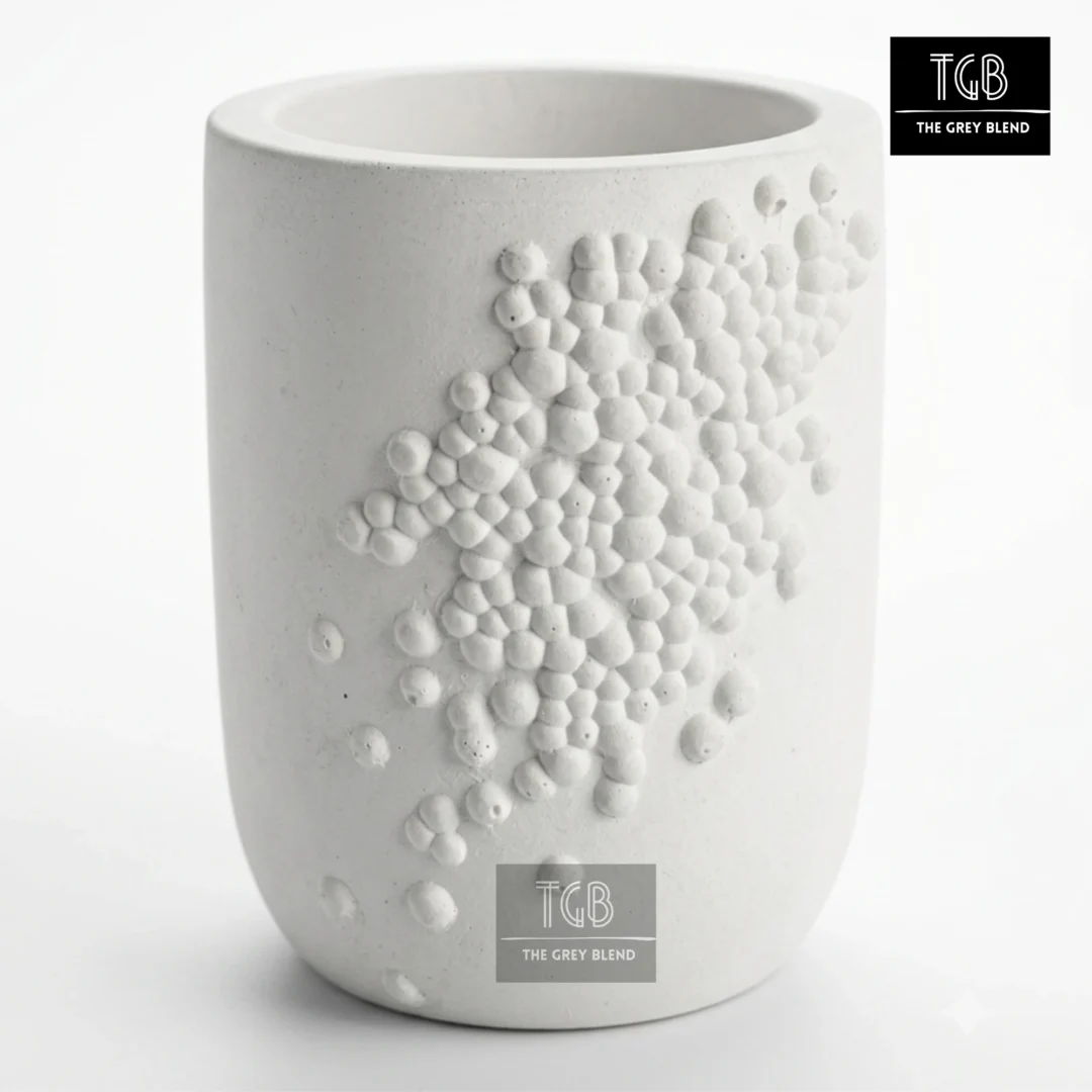 Handcrafted white concrete pen holder with minimalist bubble relief design for office desks and study tables.