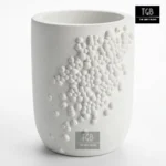 Handcrafted white concrete pen holder with minimalist bubble relief design for office desks and study tables.