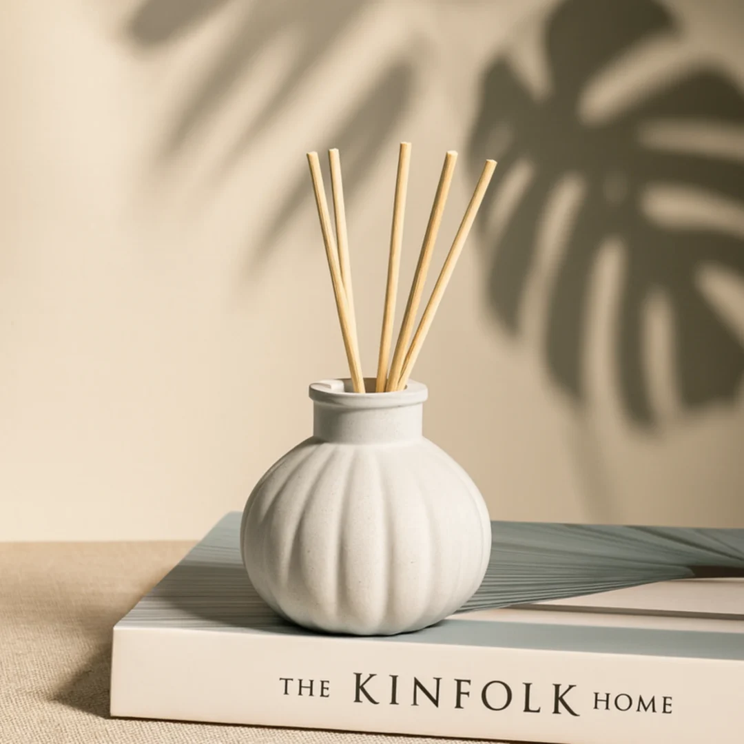 White handcrafted concrete reed diffuser bottle with 5 natural reed sticks for modern home decor